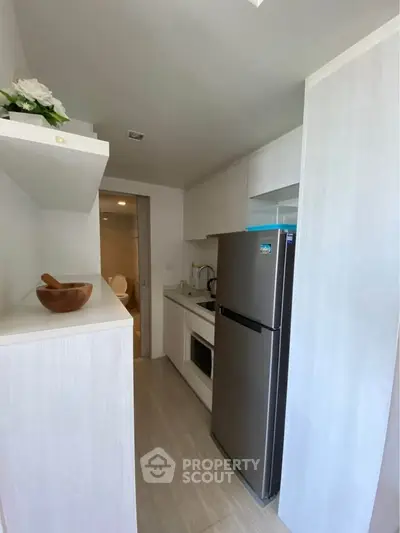Modern compact kitchen with sleek appliances and minimalist design