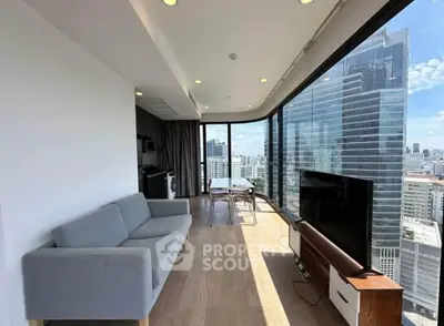 Modern living room with panoramic city views and stylish furnishings in a high-rise apartment.