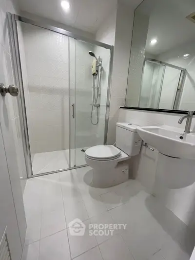 Modern bathroom with glass shower and sleek fixtures