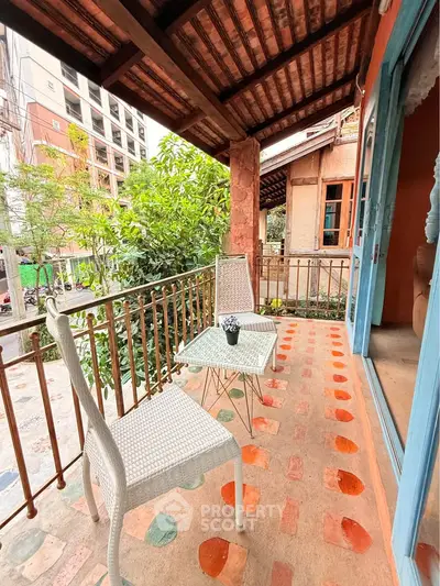 Charming balcony with rustic decor and city view, perfect for relaxation.