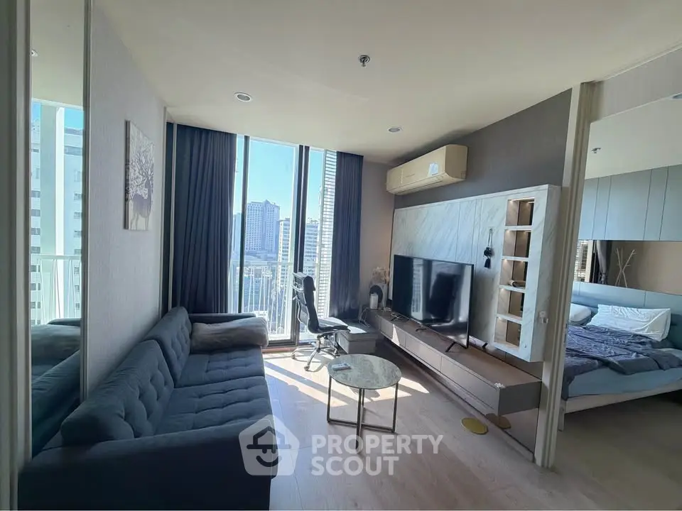 Modern living room with city view, sleek furniture, and natural light