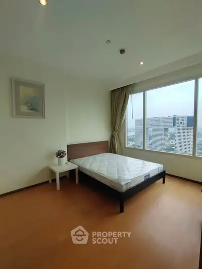 Spacious bedroom with city view and natural light