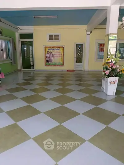 Spacious tiled room with colorful walls and decorative elements, ideal for versatile use.