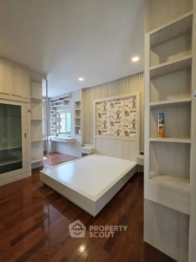 Modern bedroom with sleek built-in shelves and stylish wood flooring