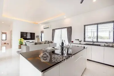 Luxurious open-plan living room and kitchen with modern decor and sleek finishes.