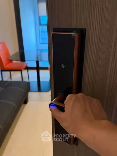 Modern smart lock on apartment door with stylish interior view