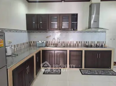 Modern kitchen with dark wood cabinets and gas stove