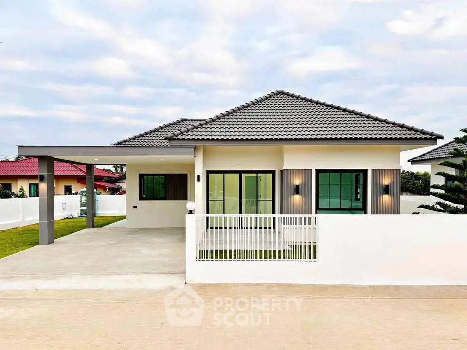Modern single-story house with sleek design and spacious driveway