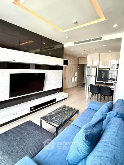 Modern living room with sleek entertainment center and cozy blue sofa