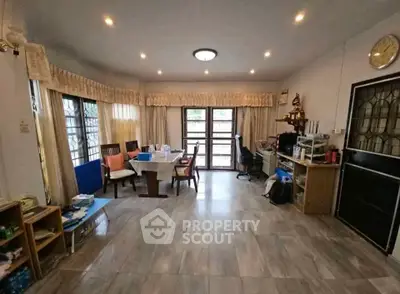 Spacious living room with modern decor and ample natural light, perfect for family gatherings.