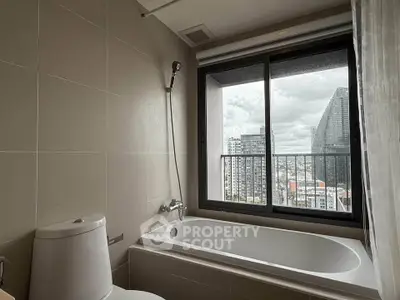 Modern bathroom with bathtub and city view from large window