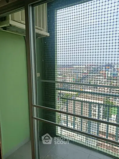 High-rise balcony with safety netting and panoramic city view