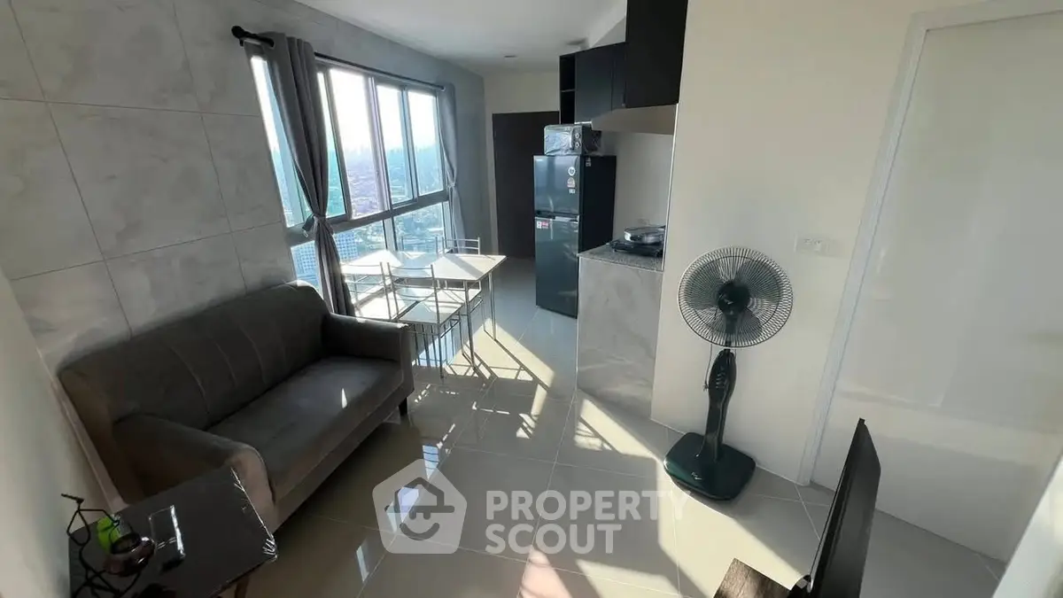 Modern apartment with open layout and city view, featuring sleek kitchen and cozy living area.