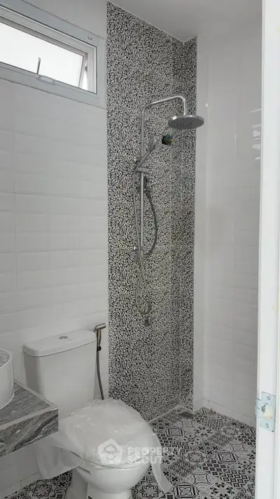 Modern bathroom with stylish tile design and rainfall showerhead