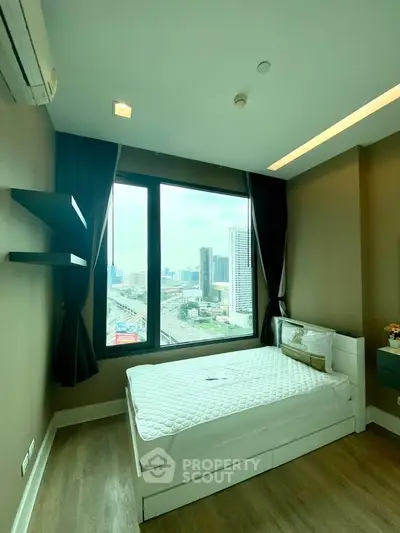 Modern bedroom with city view, featuring a cozy bed and stylish decor, perfect for urban living.