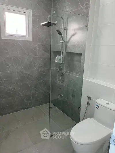 Modern bathroom with sleek shower and elegant gray tiles
