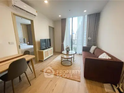 Modern living room with stylish decor and large window offering city views