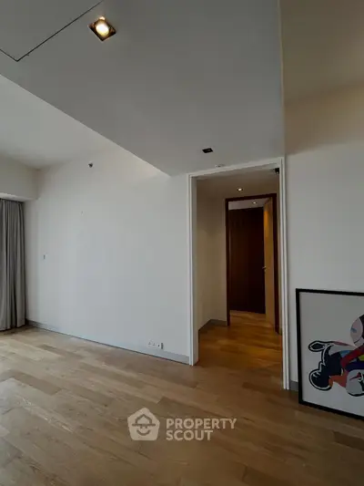 Spacious modern living room with wooden flooring and stylish lighting