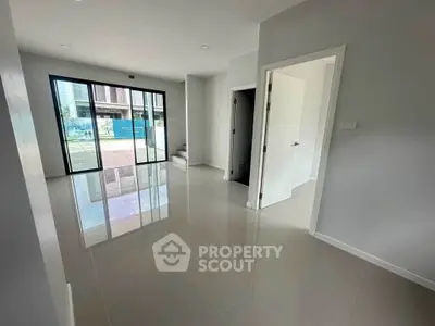 Spacious modern living room with glossy tile flooring and large windows