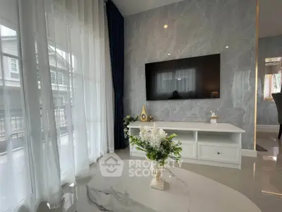 Elegant living room with marble floors, large TV, and stylish decor