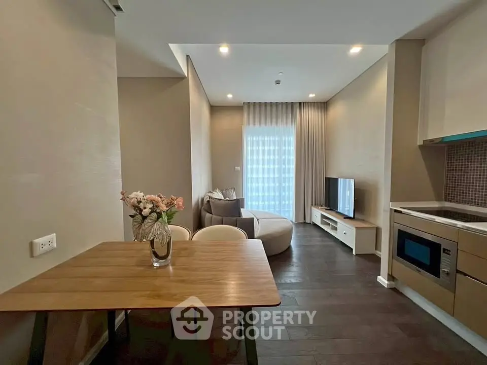 Modern living room with sleek furniture and open kitchen layout