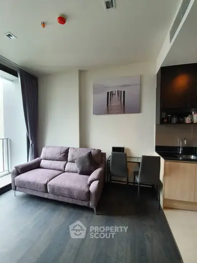 Modern living room with cozy sofa and stylish kitchenette in a chic apartment