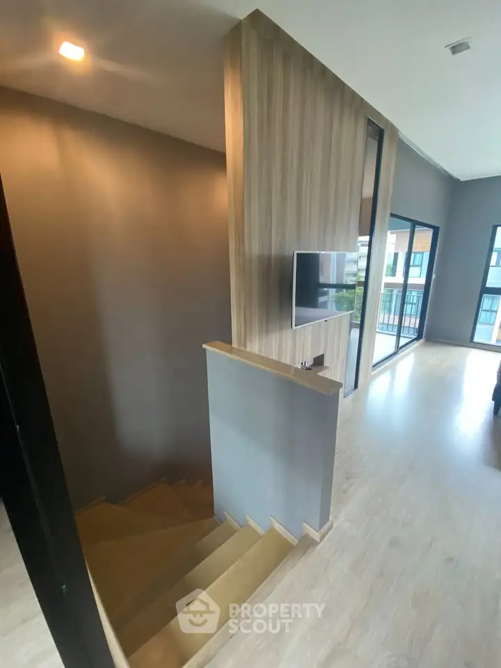 Modern interior with wooden staircase and large windows in a stylish home