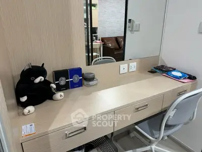 Modern study area with sleek desk, mirror, and comfortable chair in a stylish apartment.