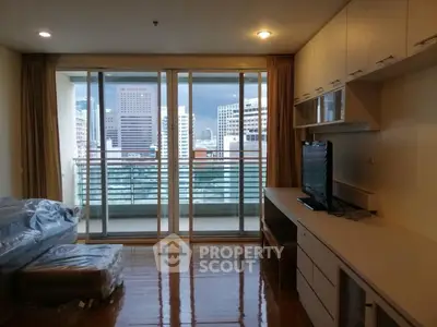Spacious living room with city view and modern furnishings