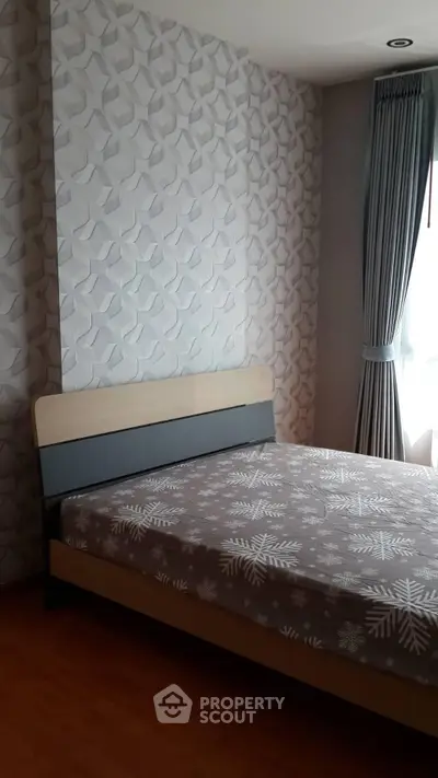 Modern bedroom with stylish wallpaper and natural light