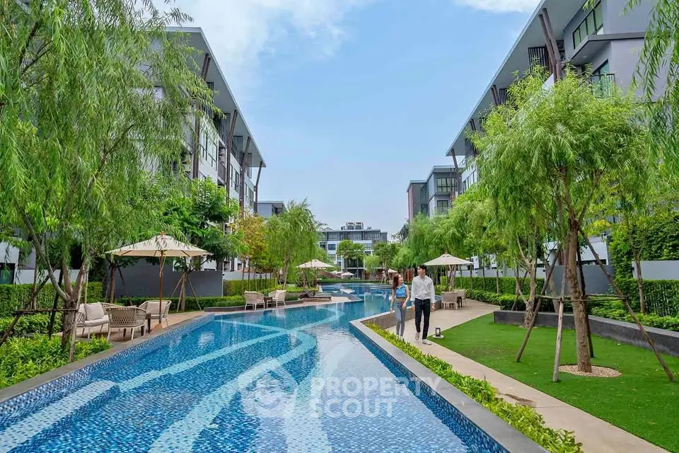 Luxurious residential complex with a stunning outdoor pool and lush greenery.