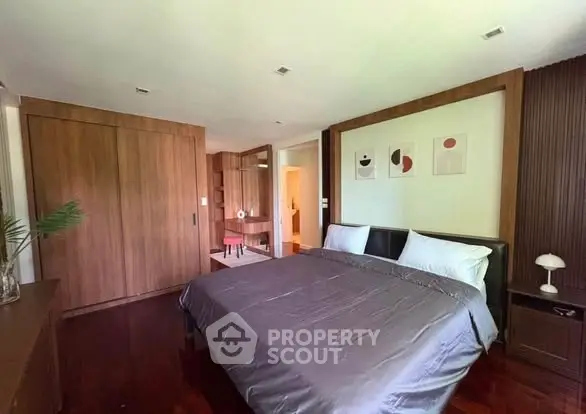 Spacious bedroom with modern decor and wooden accents