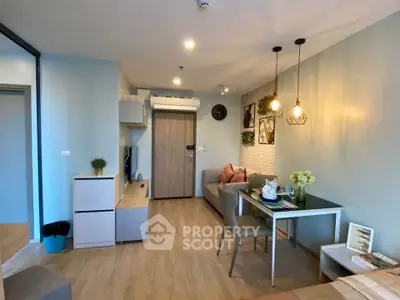 Modern living room with stylish decor and open layout, featuring cozy seating and elegant lighting.