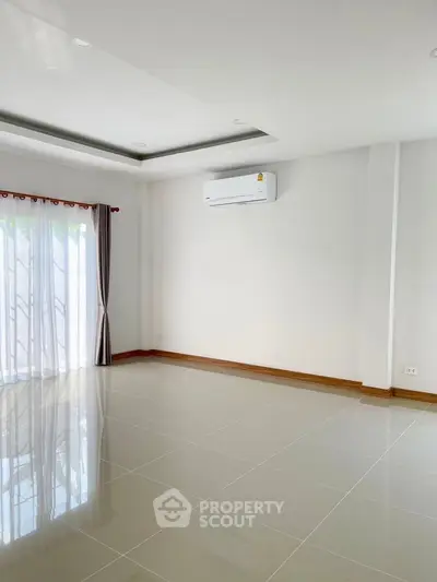 Spacious empty room with glossy tiled floor and large window, perfect for customization.