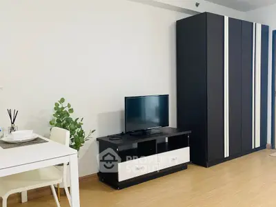 Modern living room with sleek black furniture and minimalist decor