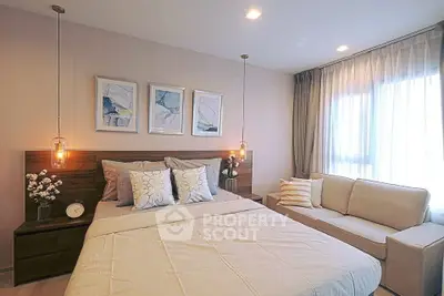 Modern bedroom with cozy decor, stylish lighting, and natural light from large window.