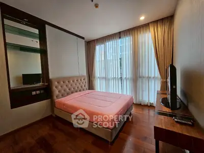 Modern bedroom with large window and stylish decor in urban apartment