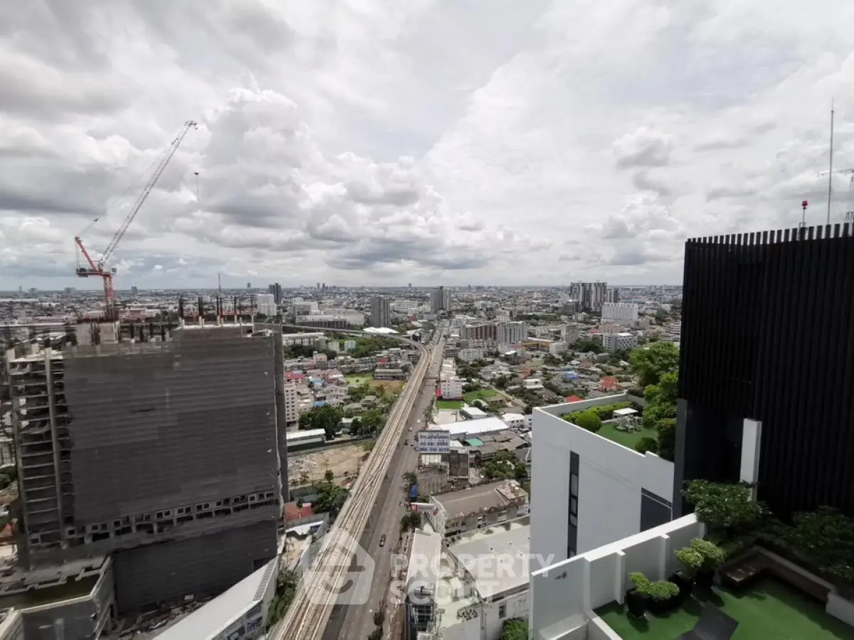 Stunning cityscape view from high-rise building with construction and greenery