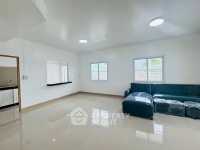 Spacious modern living room with sleek tiled flooring and natural light