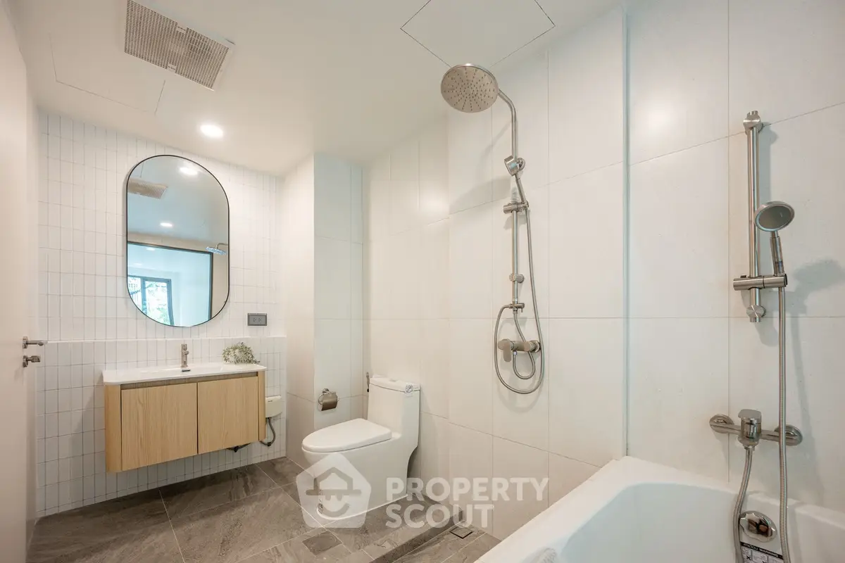 Modern bathroom with sleek fixtures and elegant design, featuring a bathtub and spacious layout.