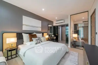 Luxurious modern bedroom with elegant decor and ample natural light.