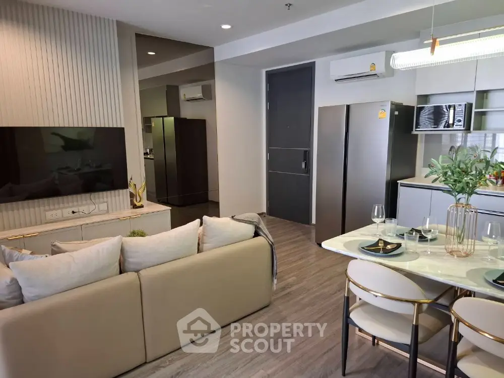 Modern open-plan living room and kitchen with stylish decor and appliances
