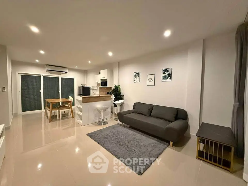 Spacious modern living room with open kitchen and stylish decor