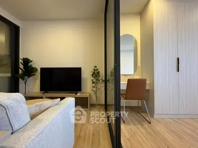 Modern living room with stylish decor and a cozy workspace corner