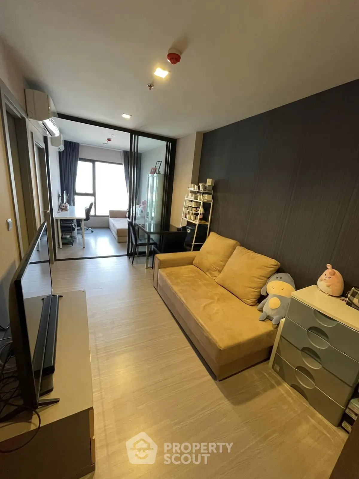 Modern living room with cozy sofa and stylish decor in a contemporary apartment.