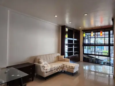 Spacious living room with modern decor and large windows for natural light.