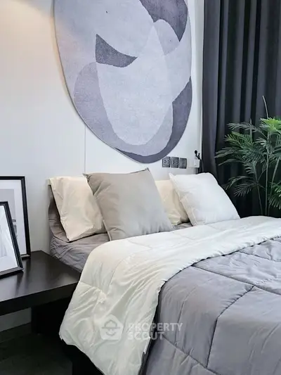 Modern bedroom with stylish decor and cozy bedding