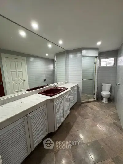 Spacious bathroom with dual sinks and modern shower in luxury home