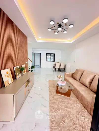 Modern living room with stylish lighting and cozy furniture in a spacious open layout.