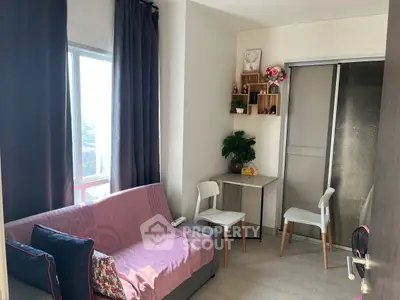 Cozy living room with natural light, modern decor, and a small dining area, perfect for urban living.